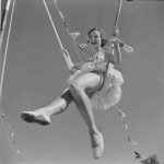 Circus Performer sitting on a cloud swing